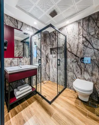 a bathroom with a shower and a toilet at Heaven Premium Hotel Restaurant & Airport Shuttle in Arnavutköy