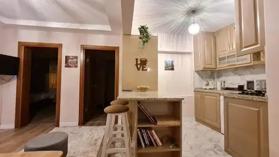 a kitchen with a ladder in the middle of a room at Cozy Home Next to Green Mosque in Yıldırım