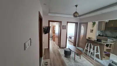 a living room with a kitchen and a dining room at Cozy Home Next to Green Mosque in Yıldırım