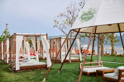 a row of swinging beds in a yard at Parmos Otel in Erdek