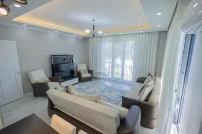 a living room with a couch and a tv at Begonvil Konaklama in Sapanca
