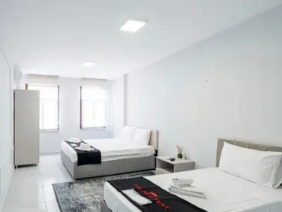 a white room with two beds and a couch at The Red Tent Suite 23 in Istanbul