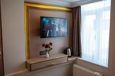 a room with a mirror and a vase of flowers on a table at Blue Zerzevan Konak Hotel in Istanbul