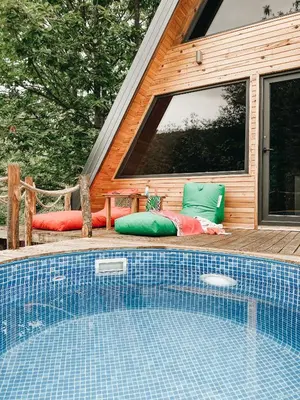 a swimming pool sitting next to a house at Loca Sapanca Bungalov in Sapanca
