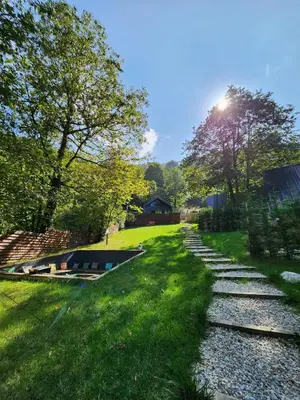 a boat sitting on the grass next to a field at Loca Sapanca Bungalov in Sapanca
