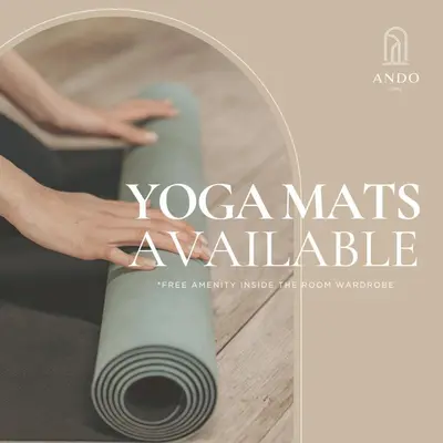 a book cover for a yoga mats avaliable with a persons hand at Ando Living Taksim House in Istanbul