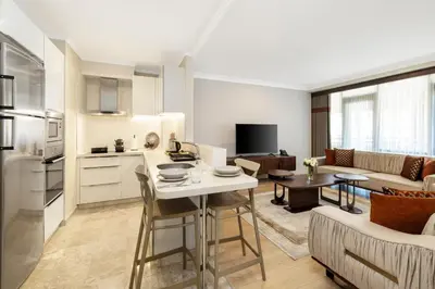 a kitchen and living room with a table and a couch at Mayar Residence Hotel in Istanbul