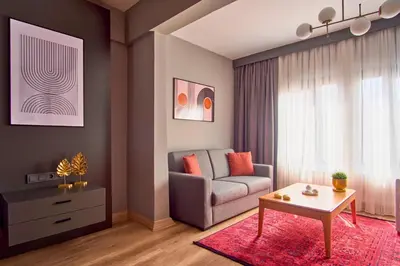 a living room with a couch and a table at TAKS-INN Hotel in Istanbul