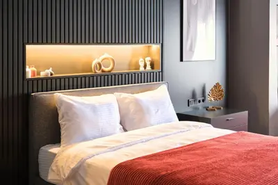 a bedroom with a bed and a shelf with olympics at TAKS-INN Hotel in Istanbul