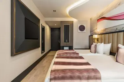 a hotel room with a bed and a flat screen tv at Ramada by Wyndham Istanbul Umraniye in Istanbul