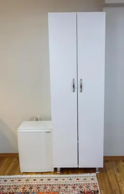 a room with two white cabinets and a rug at Fidelya Boutique Hotel in Sultanahmet