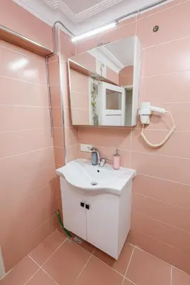 a pink bathroom with a sink and a mirror at Fidelya Boutique Hotel in Sultanahmet