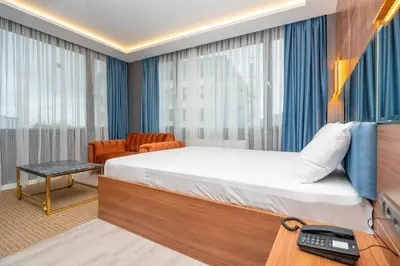 a bedroom with a bed and a desk with a telephone at Center Suite in Istanbul