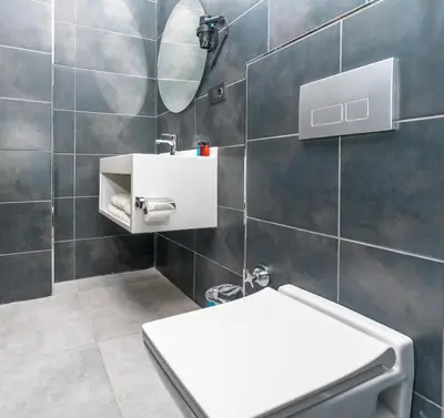 a bathroom with a toilet and a sink and a mirror at Center Suite in Istanbul