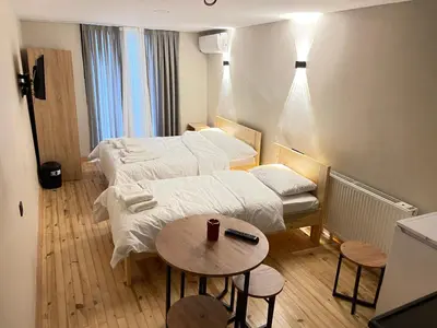 a hotel room with two beds and a table at La Perato in Istanbul