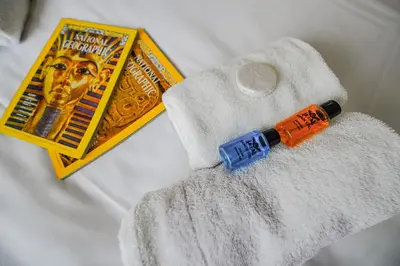 a syringe next to a book on a bed at MITANI SUITES in Istanbul