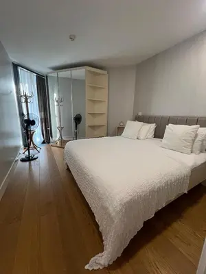 a bedroom with a large bed with white sheets at Lovely Two Bedroom Appartment Istanbul in Istanbul
