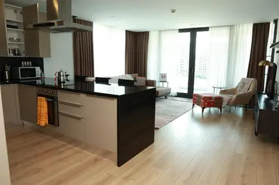 a kitchen and living room with a stove top oven at Lovely Two Bedroom Appartment Istanbul in Istanbul
