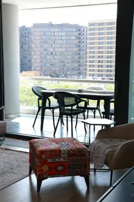 a table and chairs in a room with a large window at Lovely Two Bedroom Appartment Istanbul in Istanbul