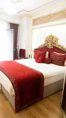 a bedroom with a large bed with red pillows at Golden Marmara Hotel in Istanbul