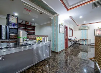 a large kitchen with a counter and a table at OTEL ÜMIT İSTANBUL in Istanbul