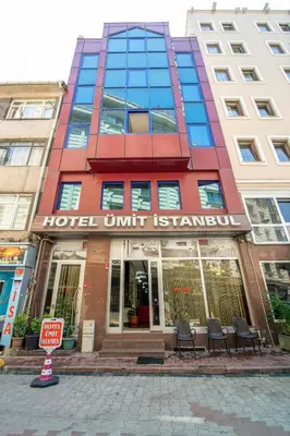 a hotel with a sign in front of a building at OTEL ÜMIT İSTANBUL in Istanbul