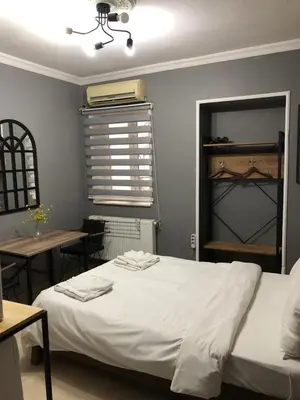a bedroom with a bed and a table and a window at Kilit no 1 in Istanbul