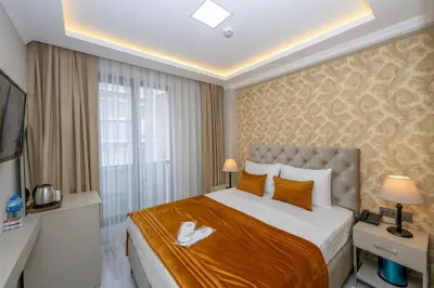 a hotel room with a large bed and a window at SKYSTAR DELUXE HOTEL in Istanbul