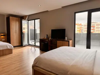 a bedroom with a bed and a flat screen tv at İNNPORT HOTEL in Gebze