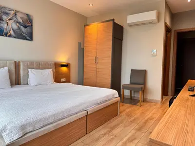 a bedroom with a bed and a desk and a chair at İNNPORT HOTEL in Gebze