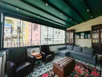 a living room with a couch and chairs and a window at The House Company in Istanbul