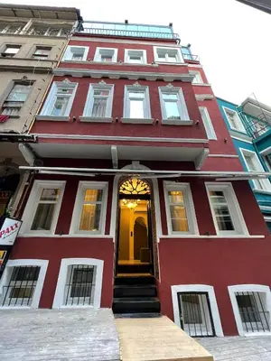 a red and white building with a yellow door at The House Company in Istanbul